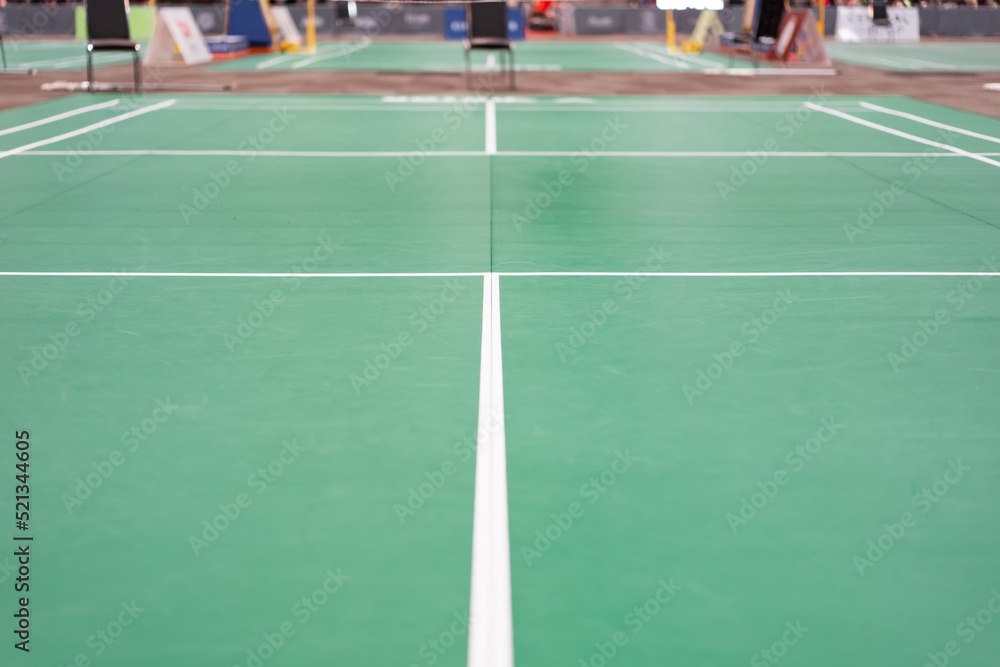Fototapeta premium empty green used badminton court background is ready for playing badminton in competition or exercise for being healthy.
