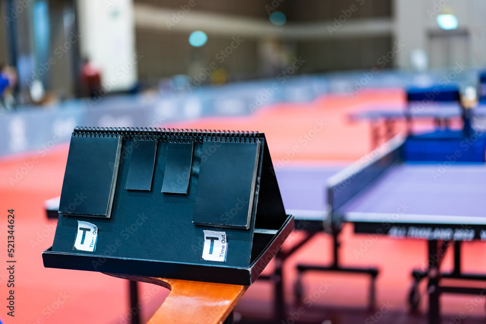 A tennis table black scoreboard is placed next to the table tennis table  for referee count the score, which acts as a blurred background of pingpong  tournament. Photos | Adobe Stock