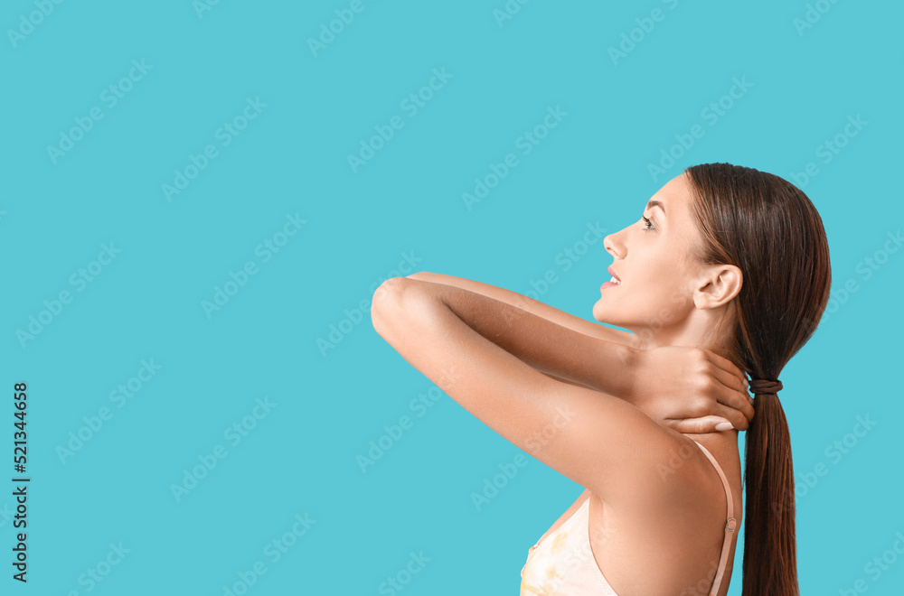 Young tanned woman on blue background Young tanned woman on blue background
