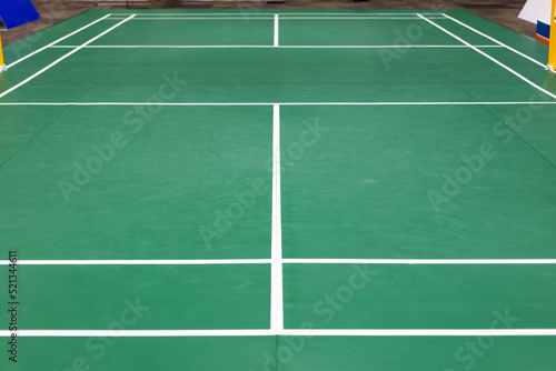 empty green used badminton court background is ready for playing badminton in competition or exercise for being healthy. © Surachetsh