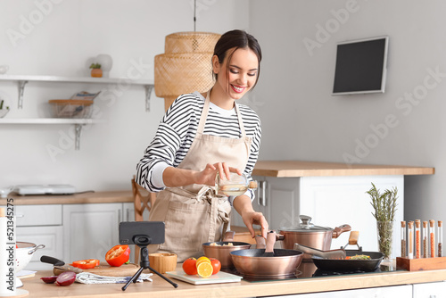 Young woman pouring oil ont...