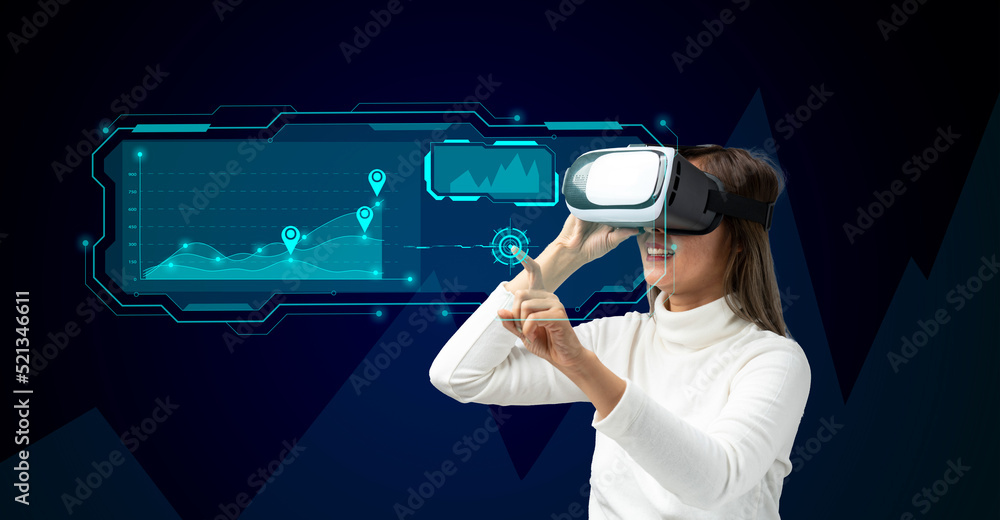Businesswoman asia in vr glasses touching graphs on a virtual screen with HUD interface. Internet of things and futuristic technologies concept. Data analytics, business intelligence.