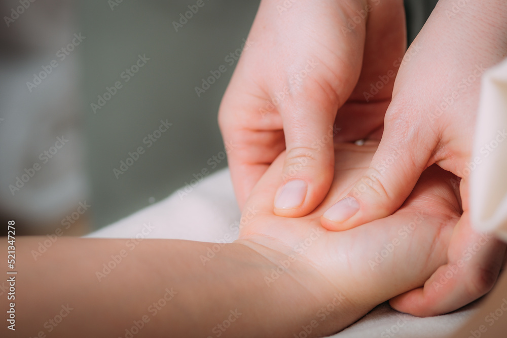 Hand massage in a massage salon, woman having a relaxing hand massage. Hand massage in a massage salon, woman having a relaxing hand massage.