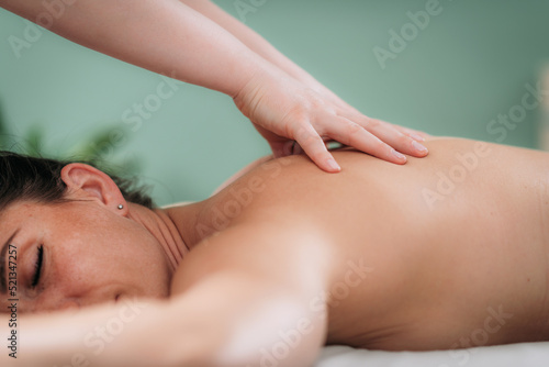 Relax massage for shoulders and neck, hands of a massage therapist massaging shoulder of a female client