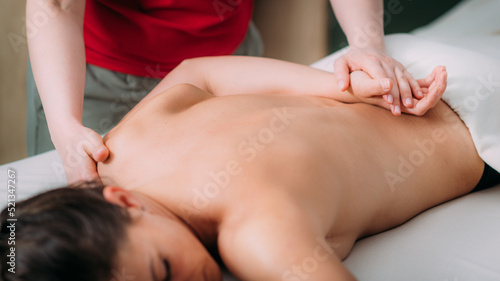 Back massage in a massage salon  woman having a relaxing back massage.