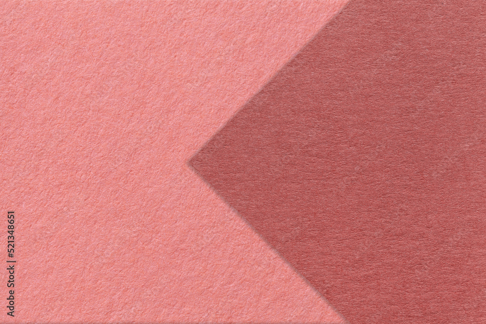 Texture of pink paper background, half two colors with maroon arrow, macro. Structure of dense craft rose cardboard. Texture of pink paper background, half two colors with maroon arrow, macro. Structure of dense craft rose cardboard.