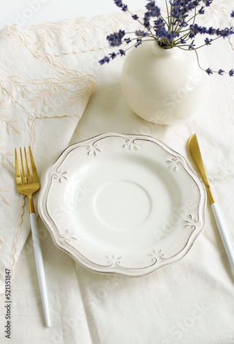 Plate mockup.Table place setting top view on beige linen tablecloth and lavender flowers in a vase.  Space for text. Wedding invitation, menu. Provence  style.