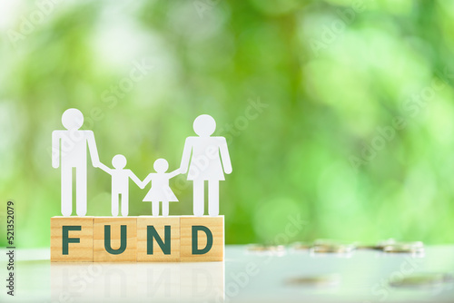 Billede på lærred Private family foundation and charitable fund for families, financial concept : Family, a father, a mother with two children stand on wood cubes with the word FUND, depicting  charitable activities