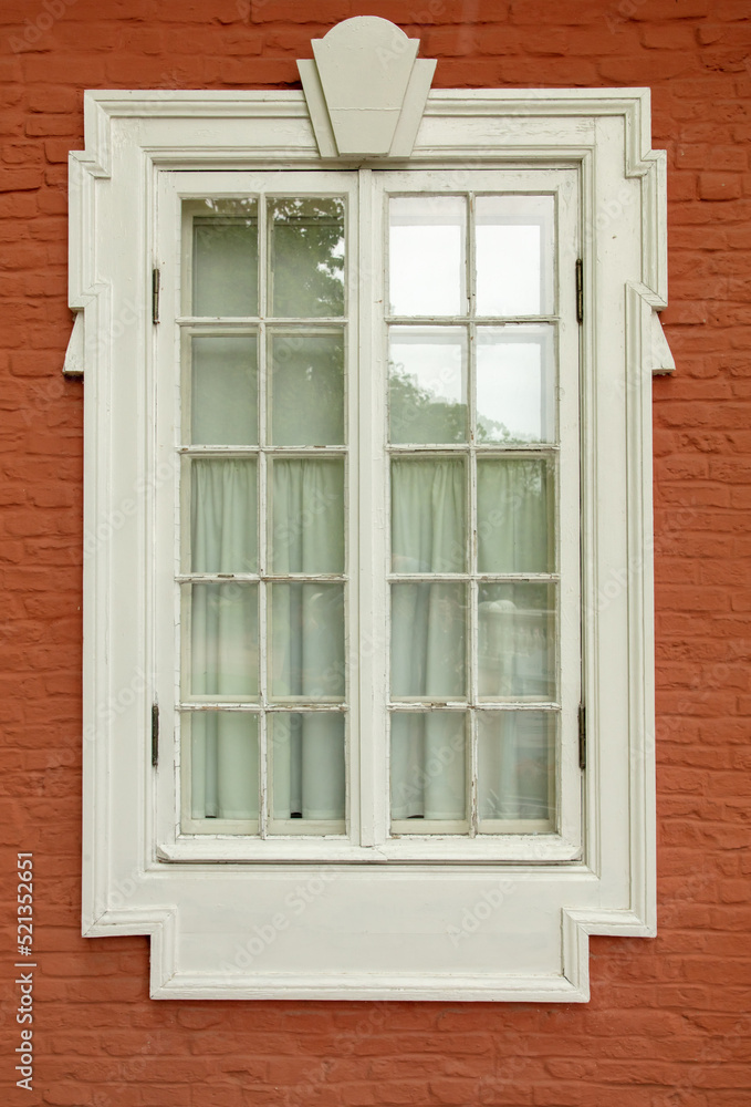 Window in the wall of a brick house.