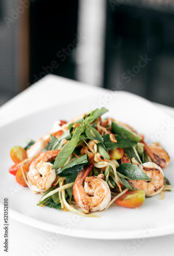 thai spicy papaya salad with fresh prawns and basil