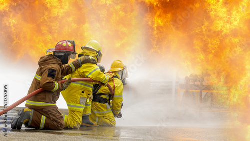 Fireman,Firefighter training Firefighters using water and fire extinguishers to fight the flames in emergency situations. in a dangerous situation All firefighters wear firefighter uniforms for safety photo