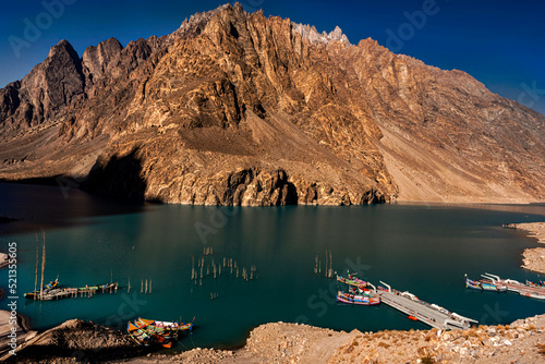 beautiful lake with green emerald  water and blue clean sky, , lake with boats , atabad lake in the mountain of hunza, lake with boats  photo