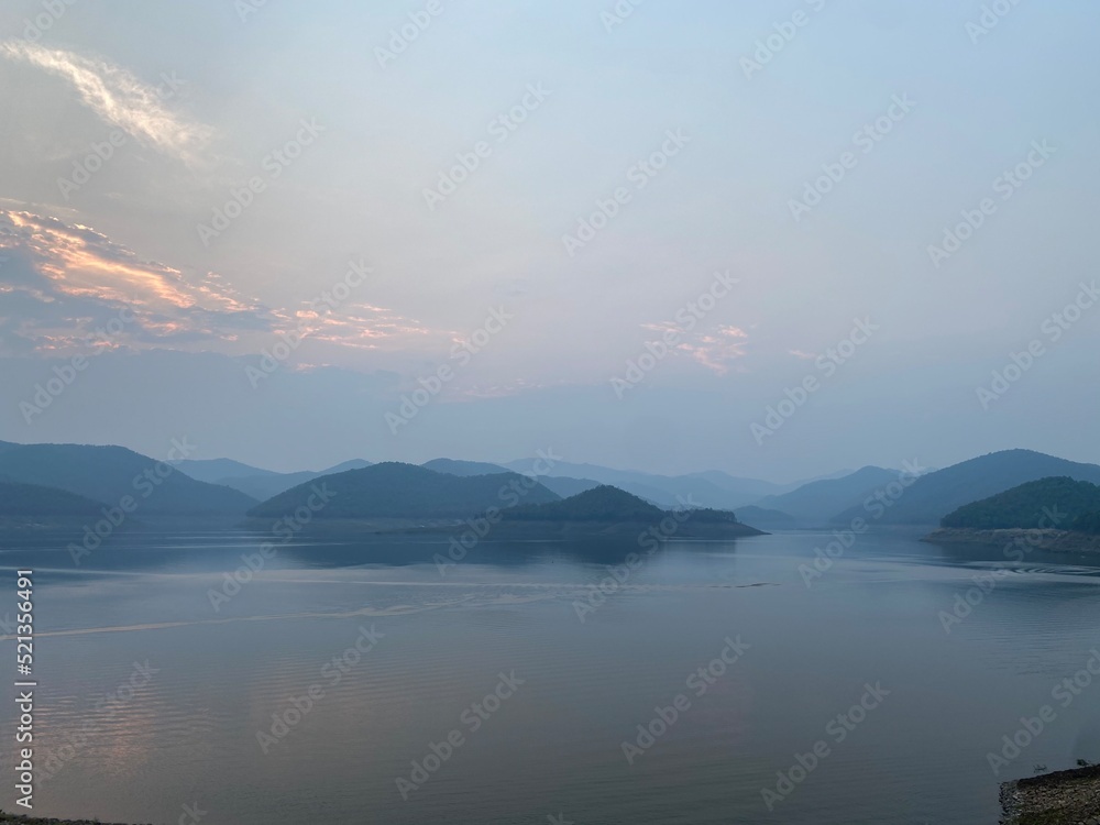 Fog over the lake and mountain landscape background.