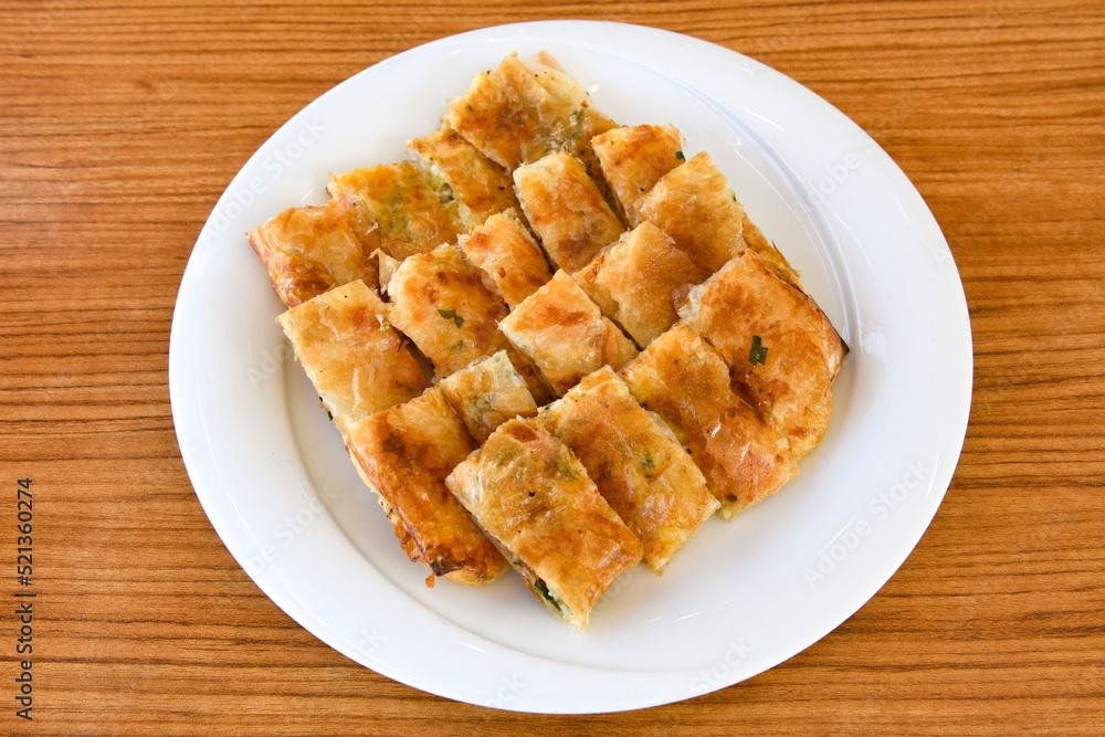Turkish style meat stuffed filo dough borek served kol boregi. Cheese and minced pie are sliced on a marble background. Turkish name: Kol Boregi. Turkish style meat stuffed filo dough borek served kol boregi. Cheese and minced pie are sliced on a marble background. Turkish name: Kol Boregi.