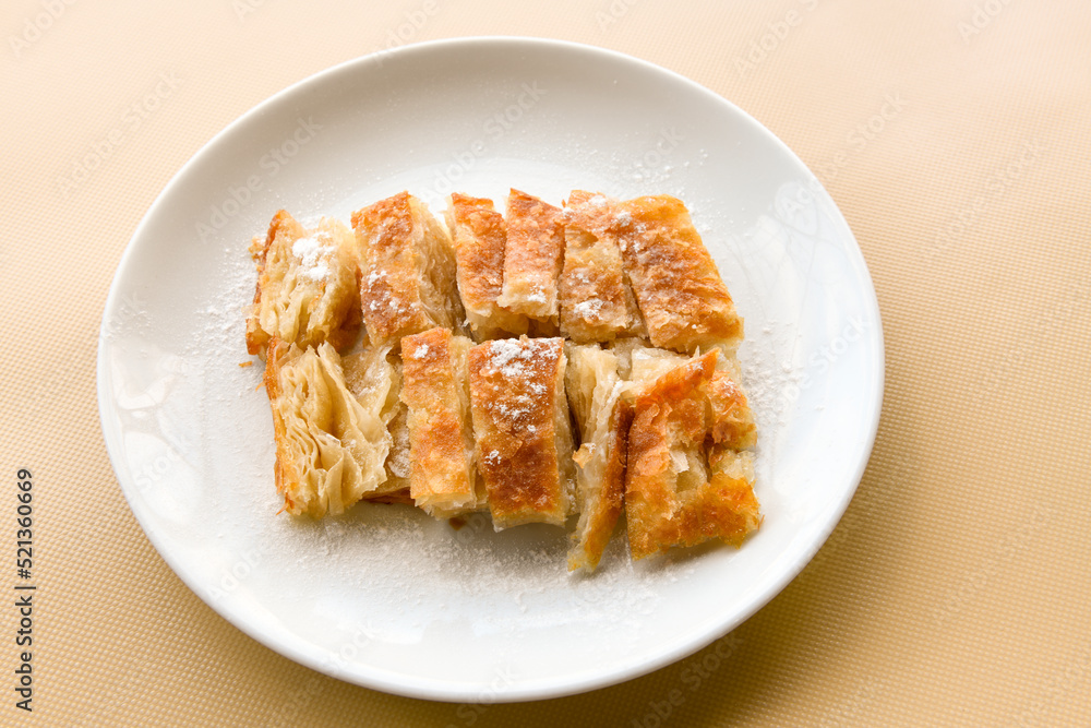 Turkish style meat stuffed filo dough borek served kol boregi. Cheese and minced pie are sliced on a marble background. Turkish name: Kol Boregi. Turkish style meat stuffed filo dough borek served kol boregi. Cheese and minced pie are sliced on a marble background. Turkish name: Kol Boregi.