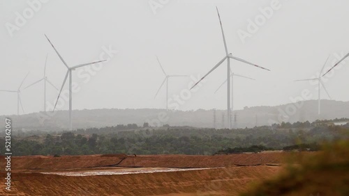 Wind Turbines Rotating Clockwise Generating Electricity Across the Sand Dunes in Vietnam. photo