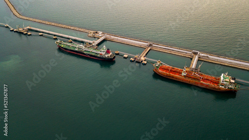 Aerial view tanker ship vessel unloading at port, Global business logistic import export oil and gas petrochemical with tanker ship transportation oil from dock refinery.