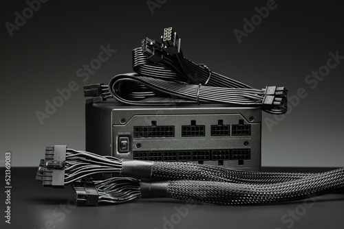 A new power supply for a desktop computer with a set of wires and cables.
