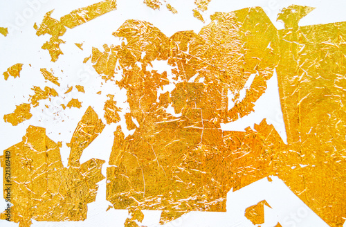 A wrinkled golden foil on the white paper. Good for any project.