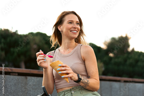 Young woman with ice cream walking in the street © fotofabrika