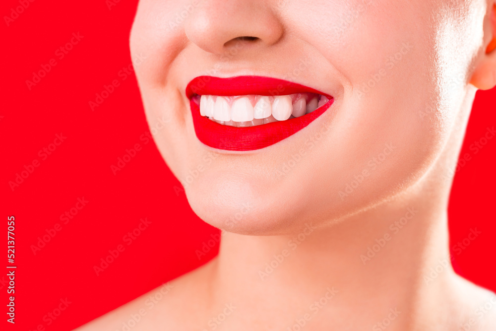 Fototapeta premium Teeth whitening. Healthy white smile close up. Beauty woman with perfect smile- lips and teeth. Beautiful Model Girl with red lips isolated on white background. Perfect skin.