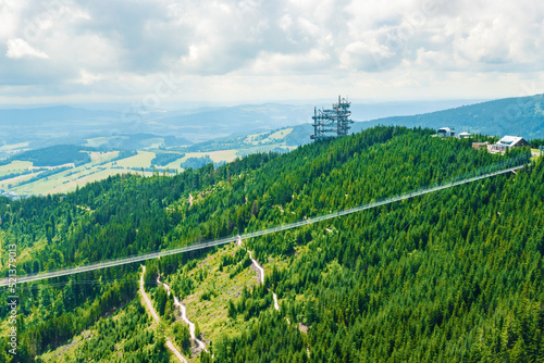 Aerial view of the worlds longest 721 meter suspension footbridge Sky bridge and observation tower the Sky walk in the forest, between mountains, Dolni Morava Ski Resort, Czech Republic. 