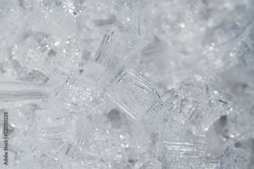 Transparent frozen small ice pieces. Abstract full frame background. 