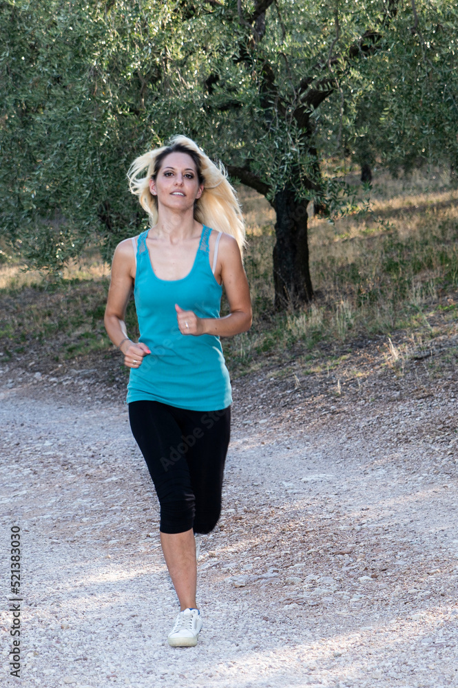 running blonde girl jogging outdoors