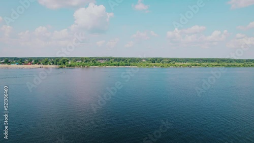 Shot on a drone. Tourists and local vacationers swim and sunbathe on an unequipped beach. Bathing season. Rest on the river. photo