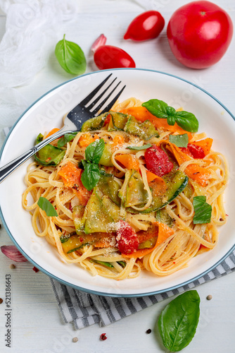 Linguine pasta with vegetables in tomato sauce.