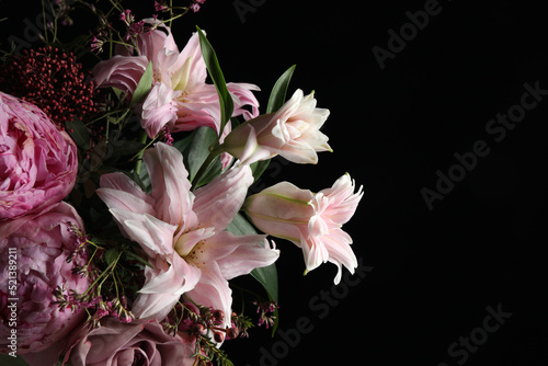 Beautiful bouquet of different flowers on dark background, closeup