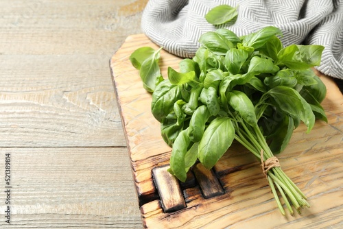 Bunch of fresh basil on wooden table