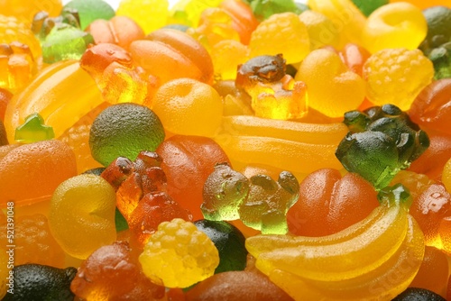 Mix of different delicious gummy candies as background  closeup