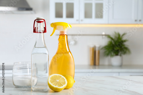Cuadro en lienzo Vinegar, baking soda and lemon on white marble table in kitchen, space for text