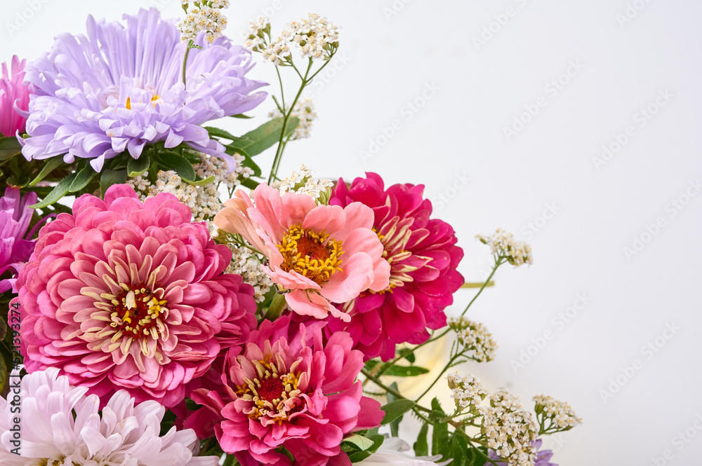 A bouquet of bright flowers on a light background.