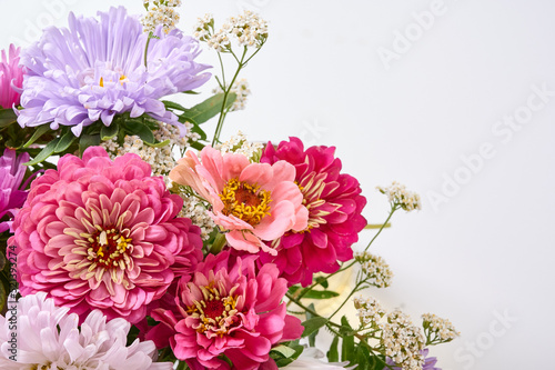 A bouquet of bright flowers on a light background.