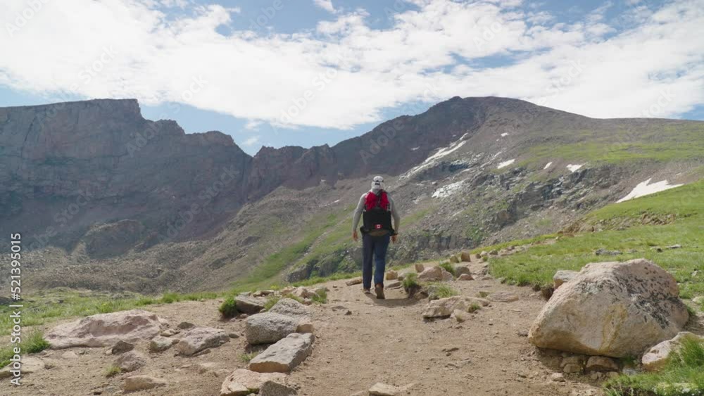 Hiker Walking towards Summit of Mount Bierstadt, Colorado Hiker Walking towards Summit of Mount Bierstadt, Colorado