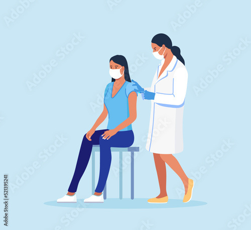 Medical doctor in protective facial mask, gloves injecting a patient, giving a coronavirus vaccine to woman. People vaccination for immunization against covid-19