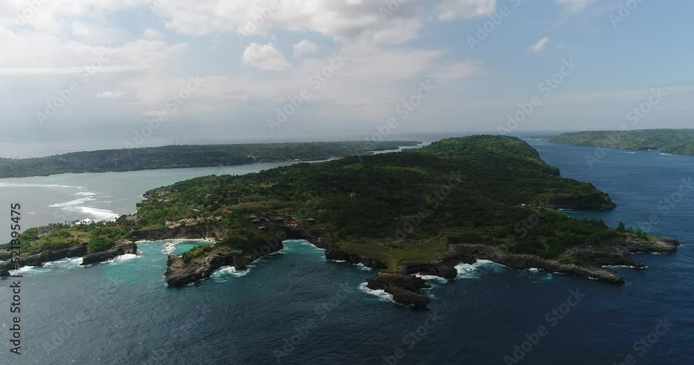 Aerial shot of a tropical island with rocky coast Aerial shot of a tropical island with rocky coast