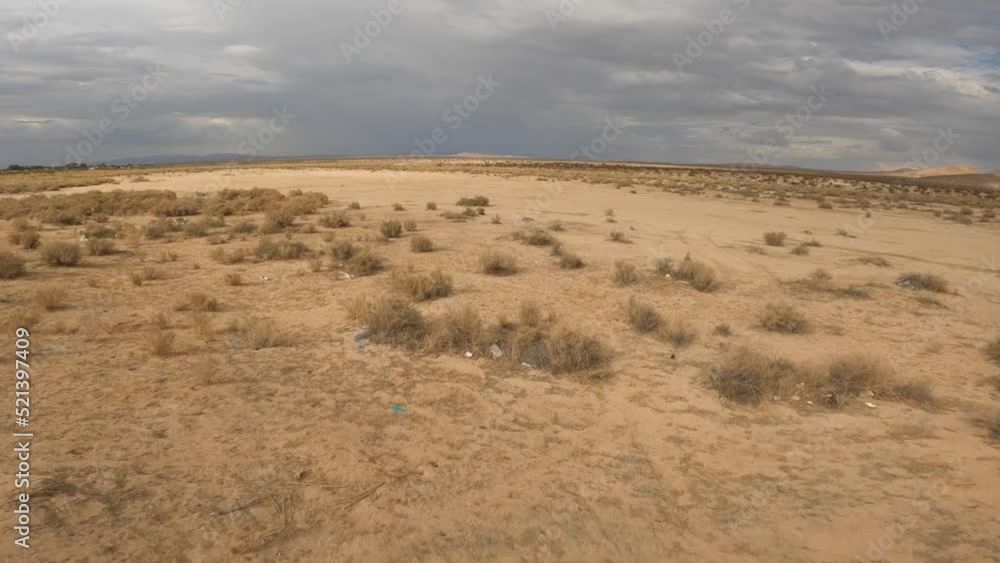 First person high-speed flight over the flat landscape of the Mojave Desert on an overcast day First person high-speed flight over the flat landscape of the Mojave Desert on an overcast day