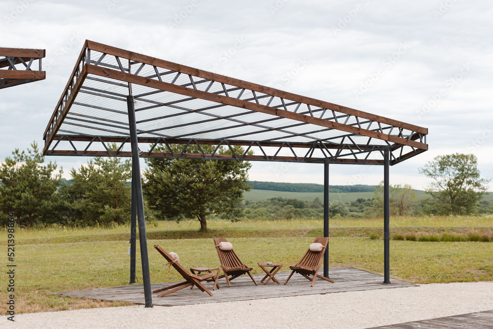 Rest area for guests. A place to relax with wooden chairs and tables Rest area for guests. A place to relax with wooden chairs and tables