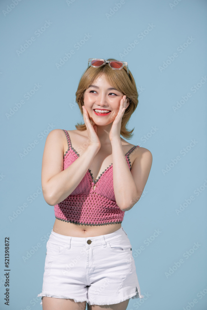 Sexy carefree woman posing near blue wall in studio. Sexy carefree woman posing near blue wall in studio.