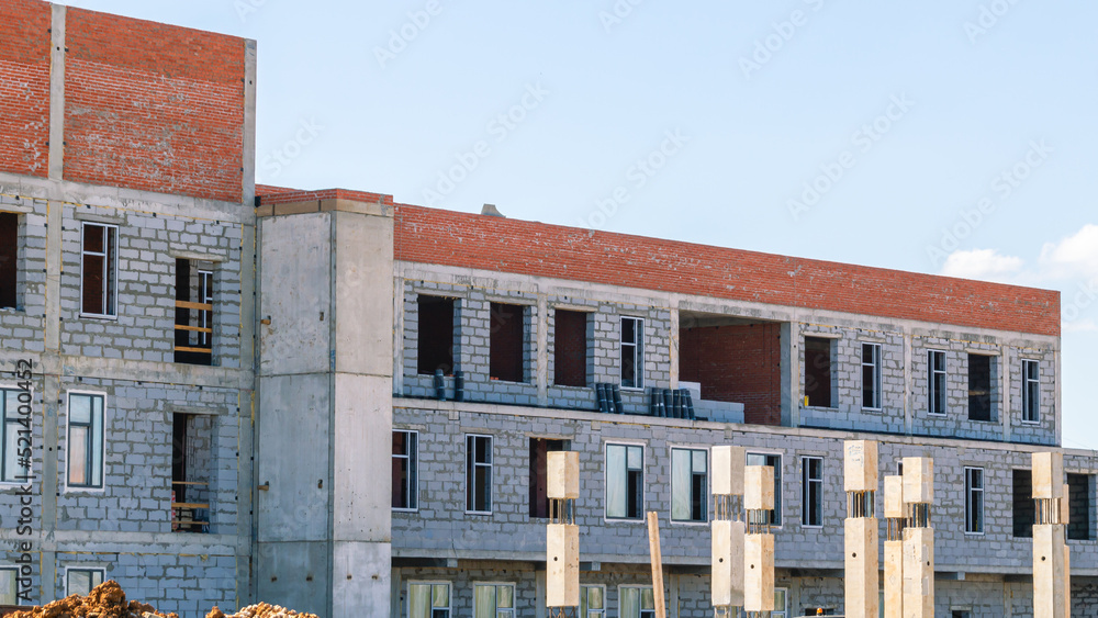 Frame of a building under construction. Construction of buildings in the city. Technologies in the construction of houses.