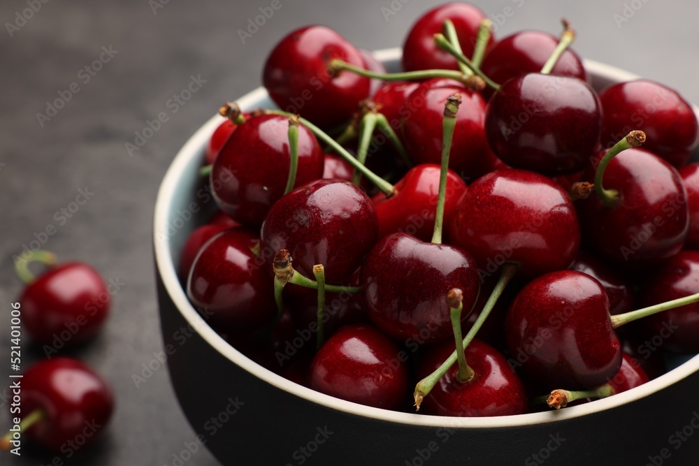 Bowl with ripe sweet cherries on grey table, closeup Bowl with ripe sweet cherries on grey table, closeup