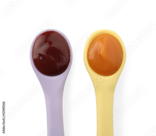 Healthy baby food in spoons on white background, top view