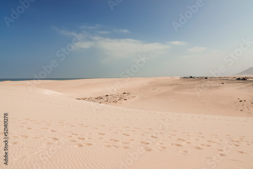 footprints on the desert of the dunes of Corralejo in Fuerteventura show the presence of tourists in the area