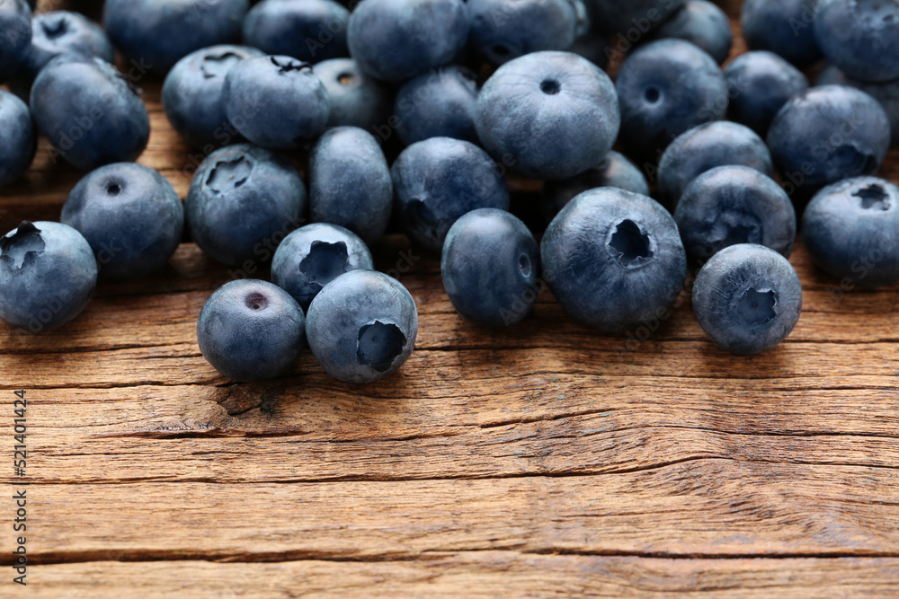Many tasty fresh blueberries on wooden table, closeup Many tasty fresh blueberries on wooden table, closeup