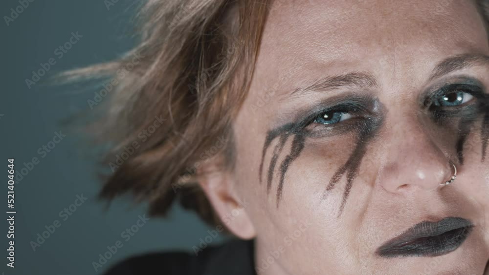 Melancholic woman with black eye make-up looking Melancholic woman with black eye make-up looking