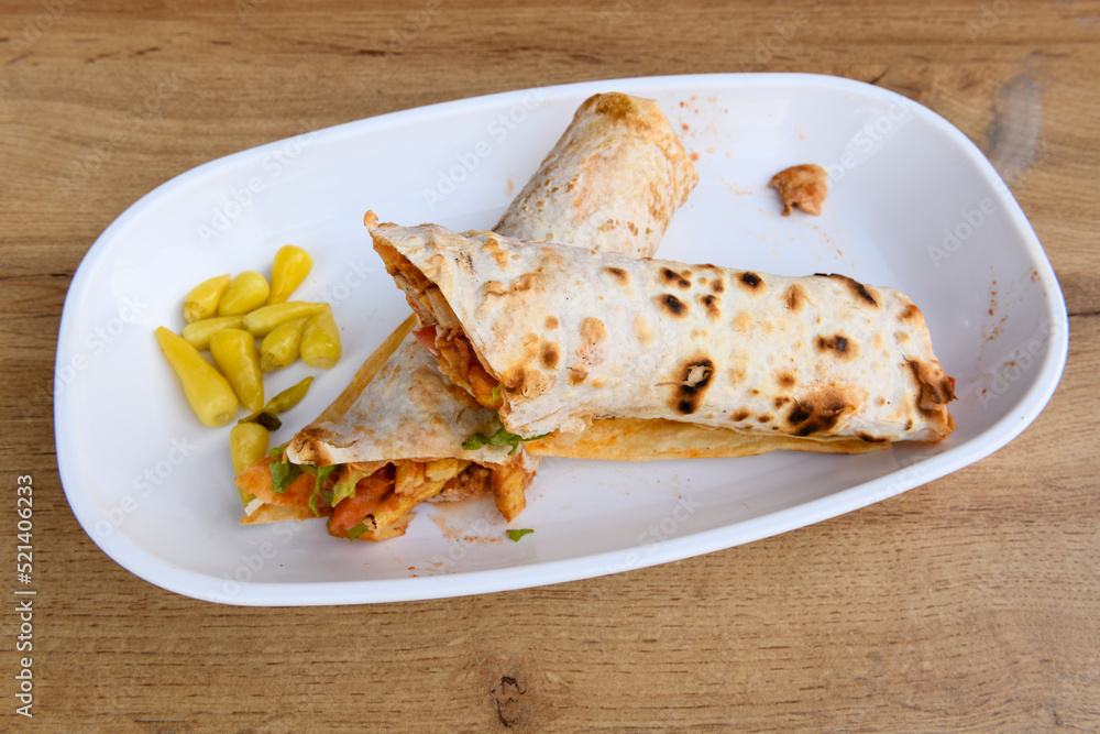 Lavash doner kebab ( doner zurna durum ) or shawarma sliced in plate isolated. Lavash doner kebab ( doner zurna durum ) or shawarma sliced in plate isolated.