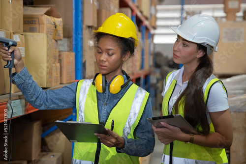 Manager supervisor dicuss with team visit store warehouse checking inventory goods in the shelf and barcode scan before distribute to factory 
 photo